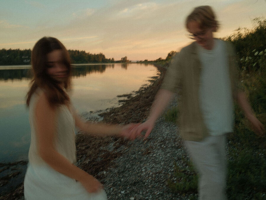 Couple at a quiet shoreline at sunset